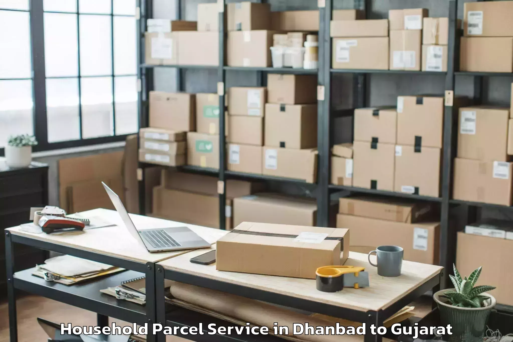 Dhanbad to Kamdhenu University Gandhinaga Household Parcel